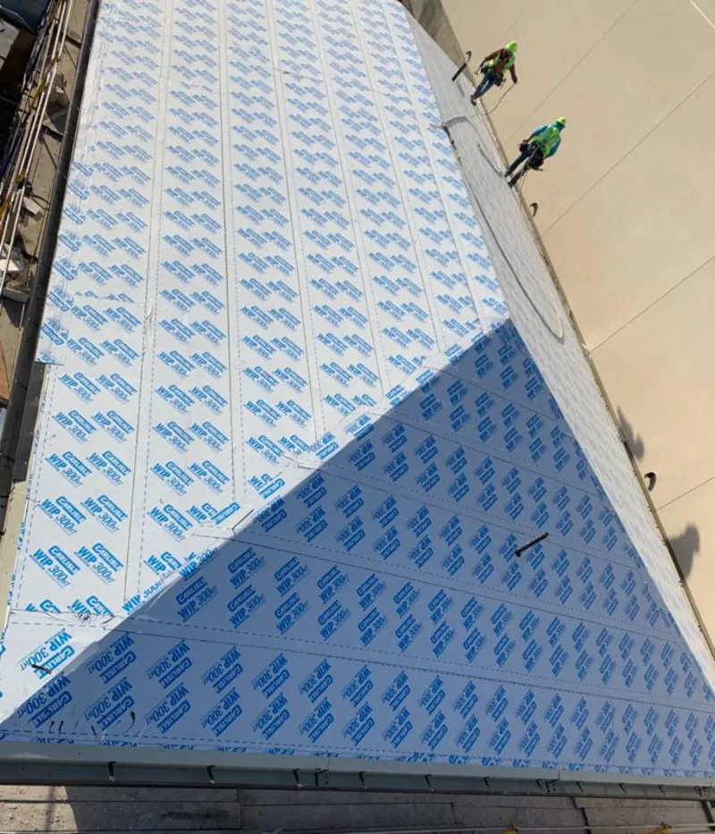 Professional roofers installing underlayment on a metal roof in Grove City